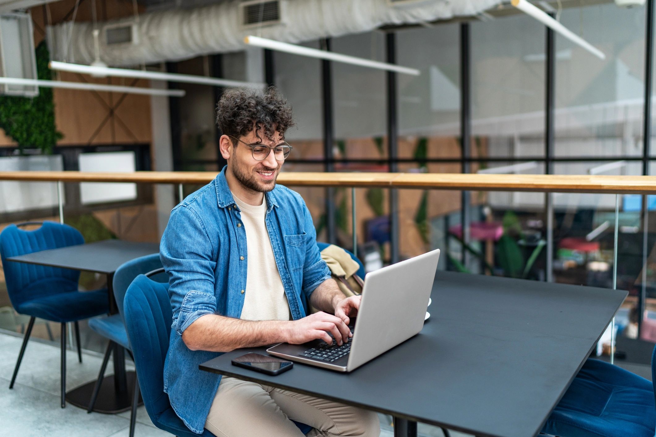 Remote worker using a laptop at a cafe table